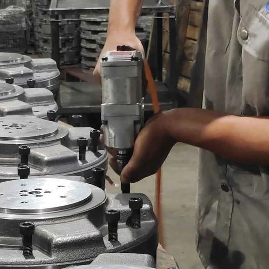 Factory workers are assembling hydraulic motors