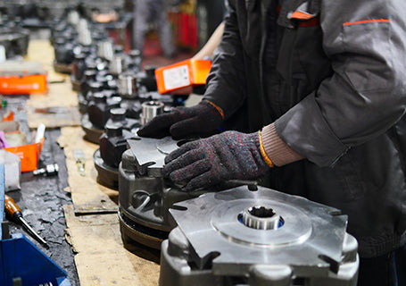 Workers are assembling hydraulic motors in a Chinese factory.